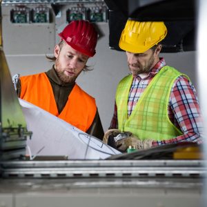 training concept - two workers studying plans