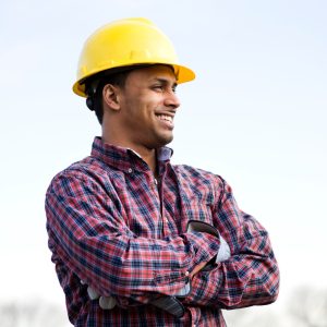 man in hard hat looking proud of his work