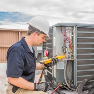 Person servicing air conditioner