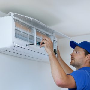 man replacing air conditioner