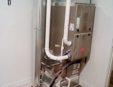 HVAC system installed in a utility room with piping and ductwork visible.