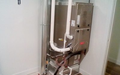 HVAC system installed in a utility room with piping and ductwork visible.