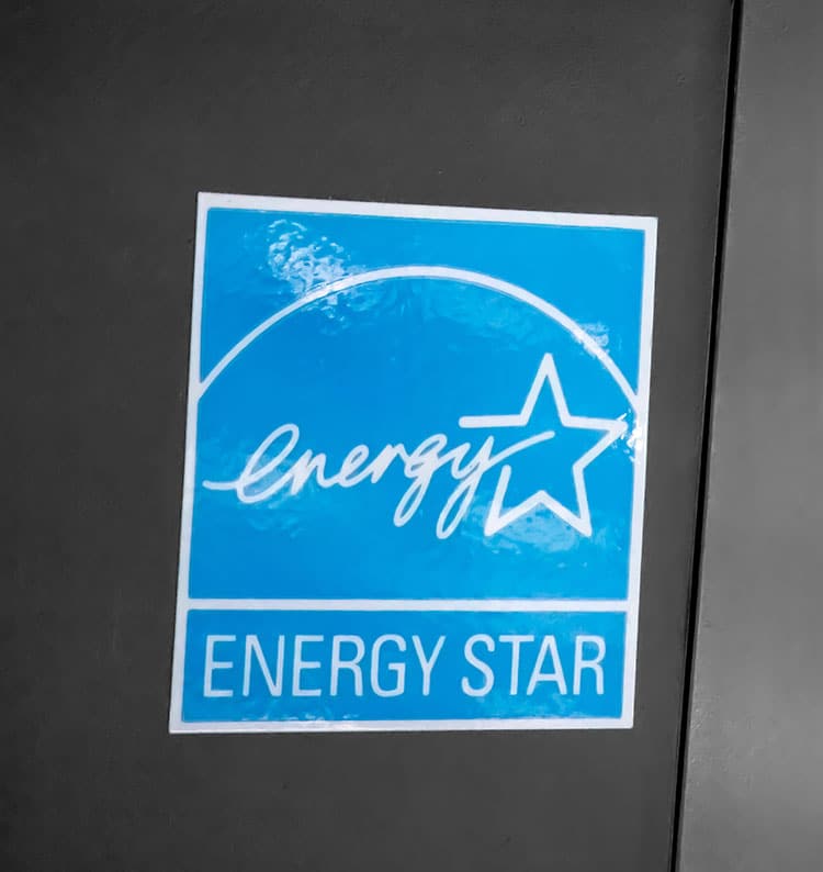 Energy Star label on a black surface, symbolizing energy efficiency certification.