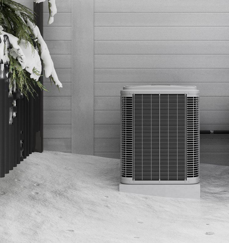 Outdoor air conditioning unit in winter snow near a house wall.