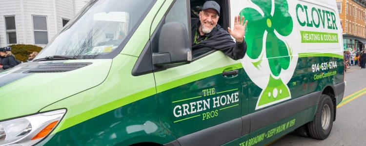 Clover HVAC technician inside a branded service van, ready to provide fast, reliable heating and cooling repairs.