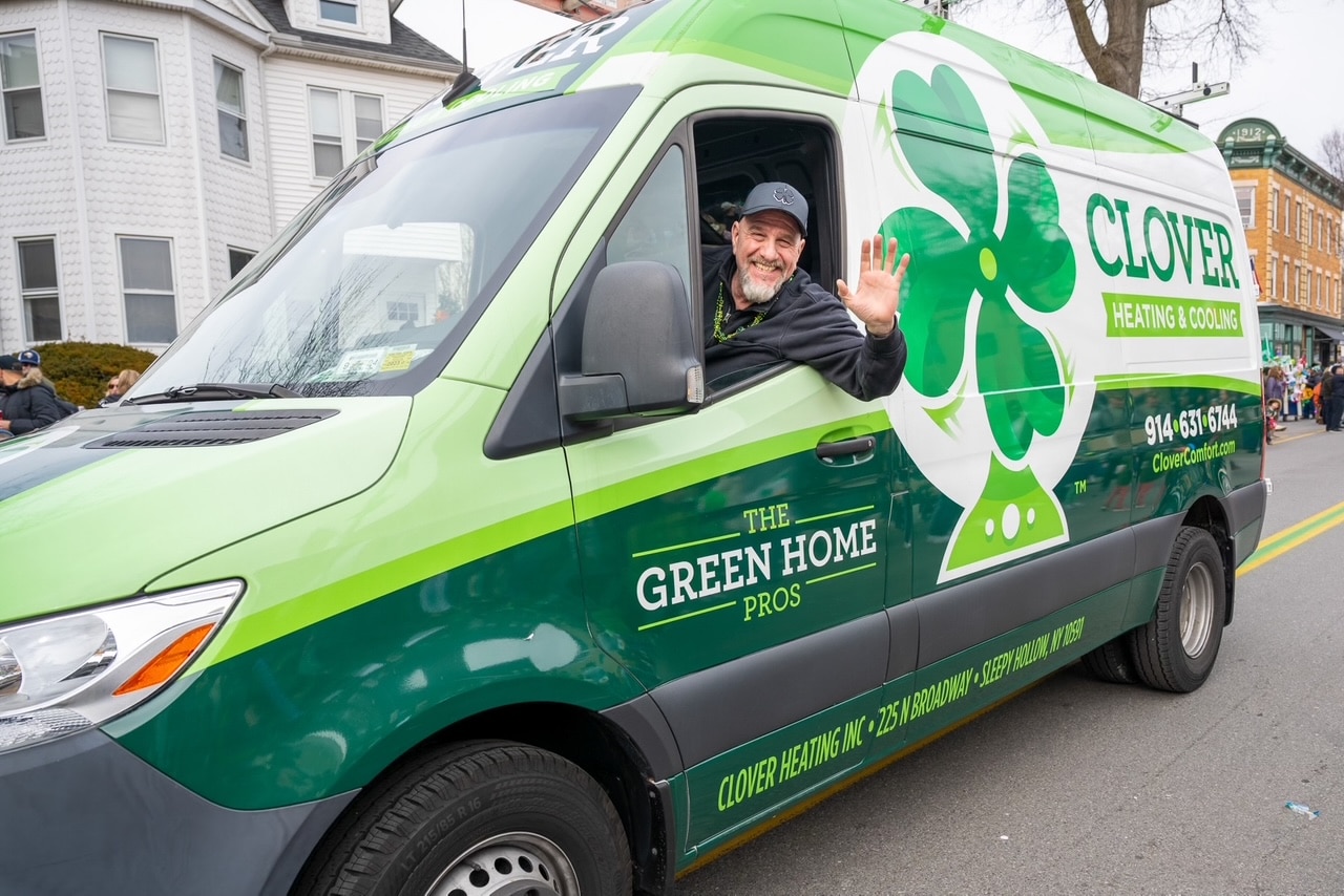 Clover HVAC technician inside a branded service van, ready to provide fast, reliable heating and cooling repairs.