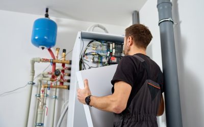 Technician installing a geothermal heat pump system in a New York home’s basement.